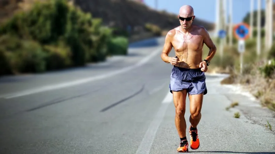 Runner enjoying music outdoors during exercise with open-ear audio technology