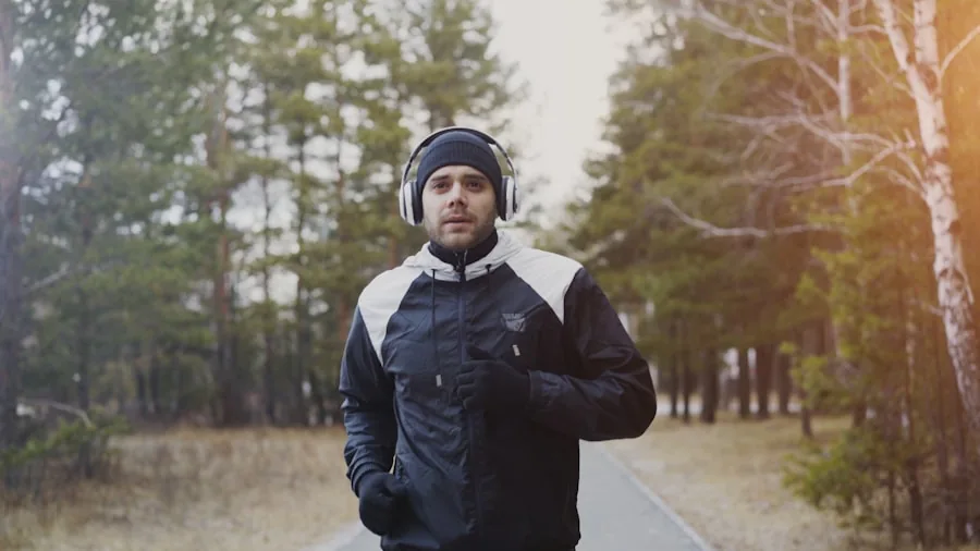 Runner exercising outdoors in wet conditions, sweat visible on athletic wear during intense workout session