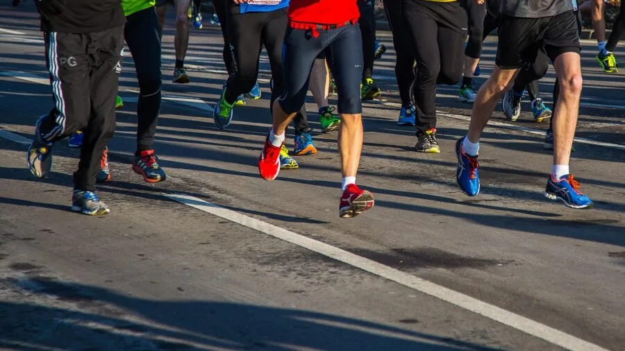 Runner in motion wearing secure-fitting earbuds during outdoor workout