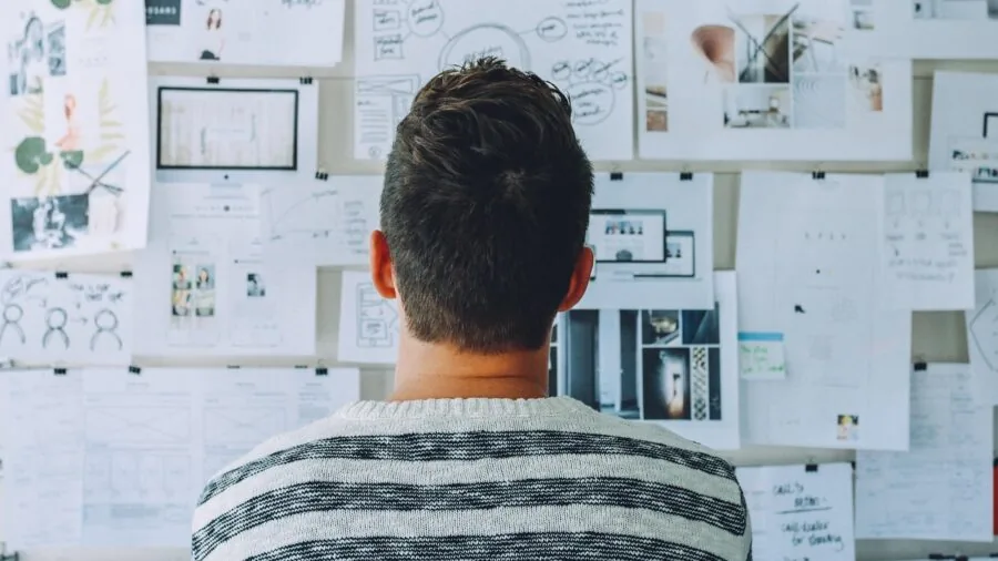 Senior person configuring smartphone settings with glasses, focused on screen setup