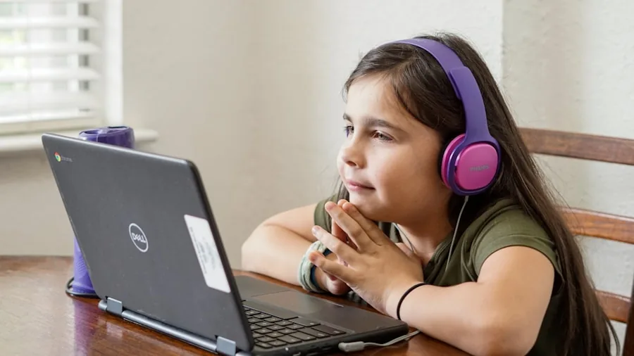 Small child using tablet or device with focus and concentration, learning digital skills