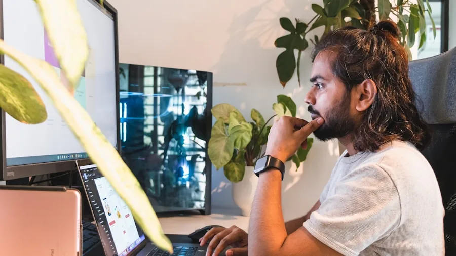 Software developer concentrating on laptop at desk during work session