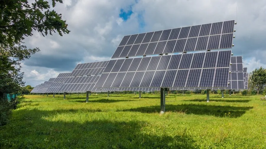 Solar panels charging equipment at campsite during daytime