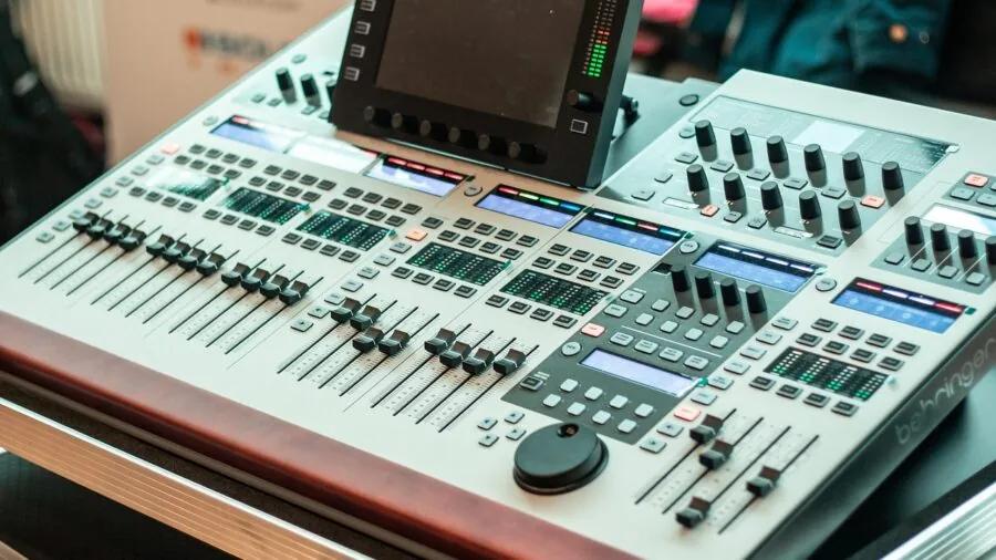Someone fine-tuning sound system settings on audio equipment in a home listening room