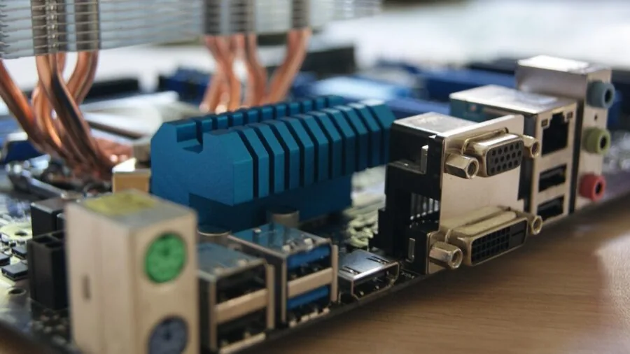 Someone installing a motherboard into a desktop computer case during a build