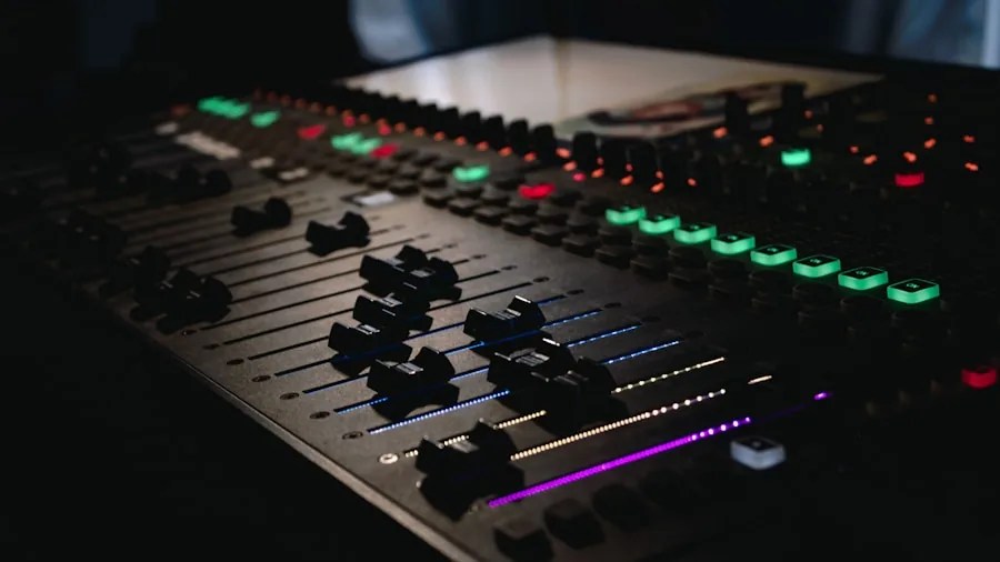 Sound engineer working at mixing console in professional studio environment