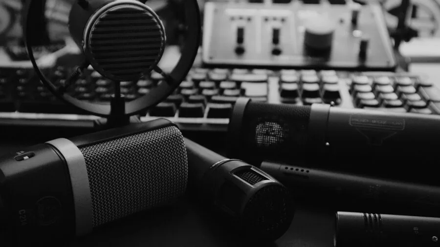 Sound engineer working at professional recording studio with microphone and mixing equipment