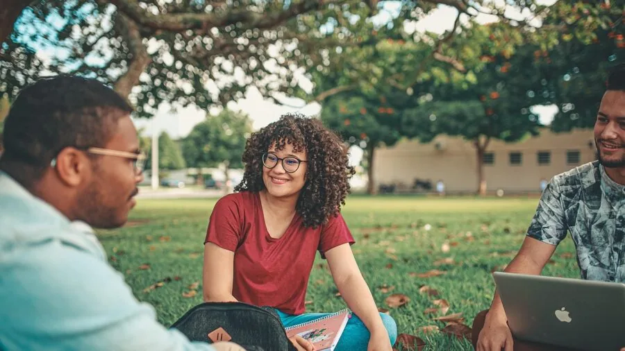 Student studying on campus with laptop and wireless connectivity for coursework