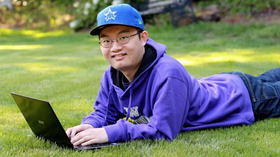 Student working on laptop during school day in natural light