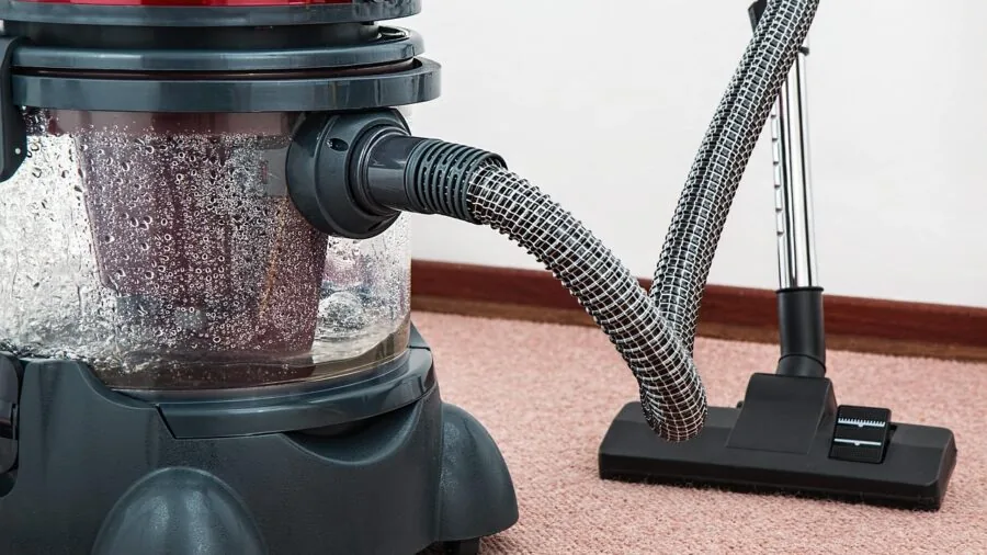 Sunlit hardwood floor with dust particles visible in natural light during cleaning