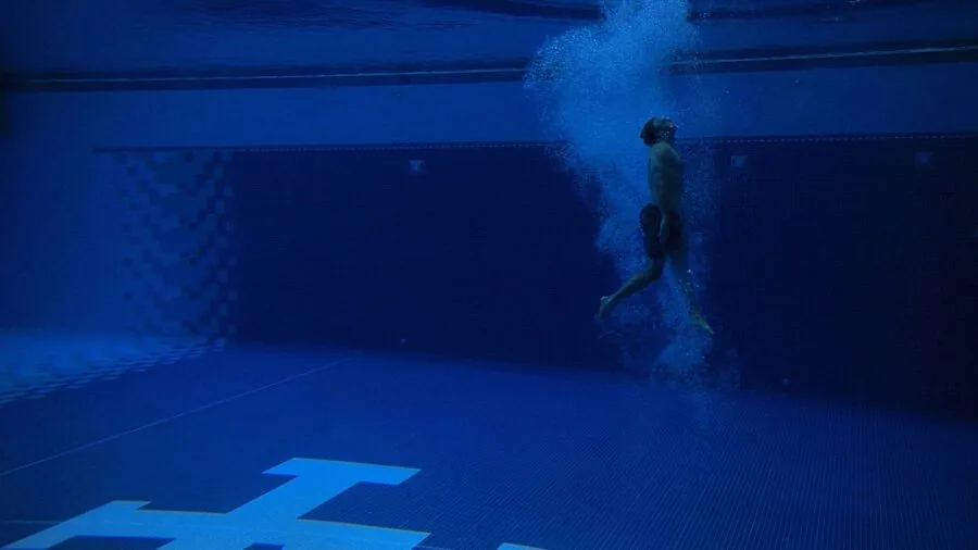Swimmer doing laps underwater in a swimming pool during training session