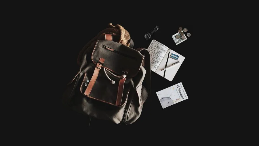 Traveler packing a lightweight backpack for a trip, showing compact gear organization