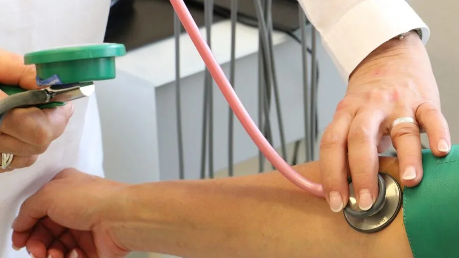 Woman monitoring health metrics during workout, checking smartwatch for heart rate and fitness data