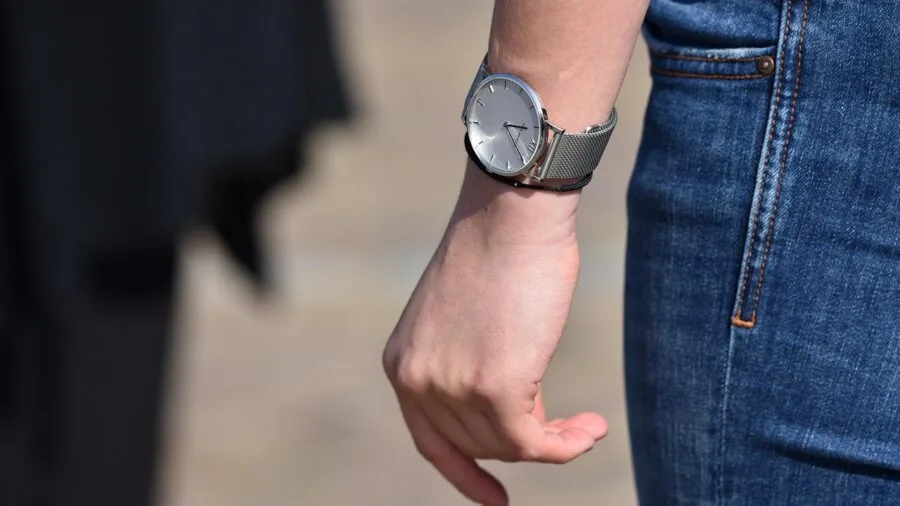 Woman wearing a delicate smartwatch on her wrist, showcasing proper fit and comfort for smaller wrists