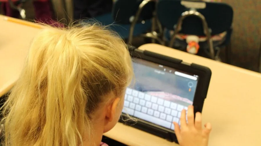 Young child engaged with tablet device for educational learning and development