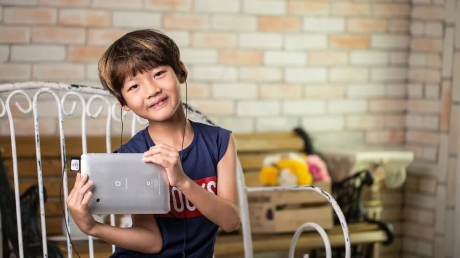 Young child enjoying music with protective headphones in a comfortable home environment