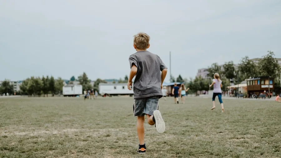 Young child jogging outside while wearing a fitness tracker on wrist during daytime exercise
