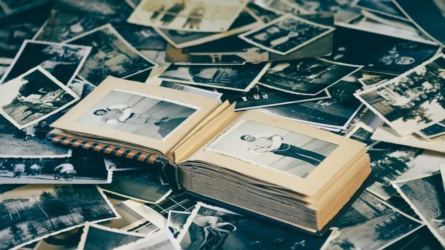 Young child looking at instant printed photographs with curiosity and joy