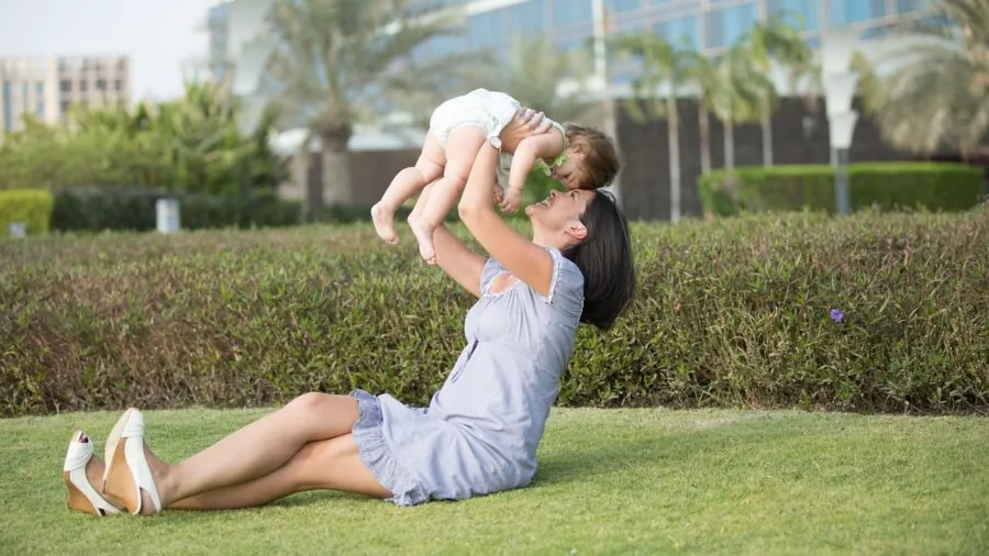 Young child waiting outdoors while device charges, learning patience during play time